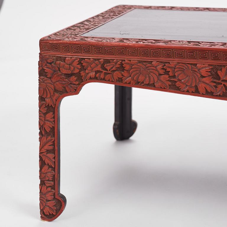 A carved lacquered table, early 20th Century.