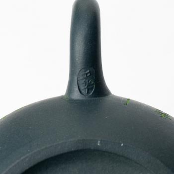 A group of three yixing teapots and a box with cover, China, 1970/80s.