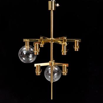 A brass chandelier with two glass globes by Hans-Agne Jacobsson, Markaryd.