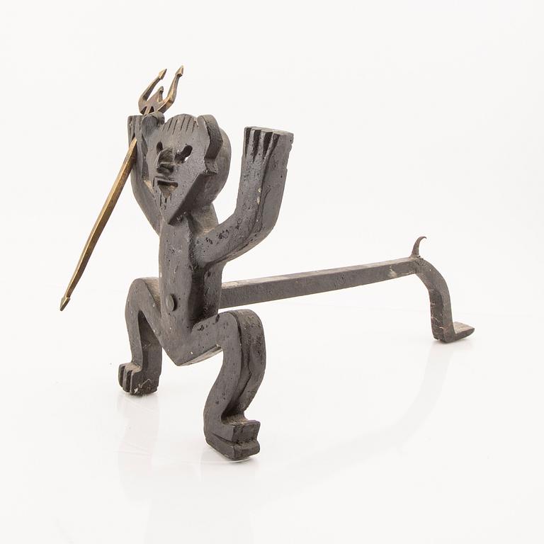 A cast iron firedog by Eskil Björklund.