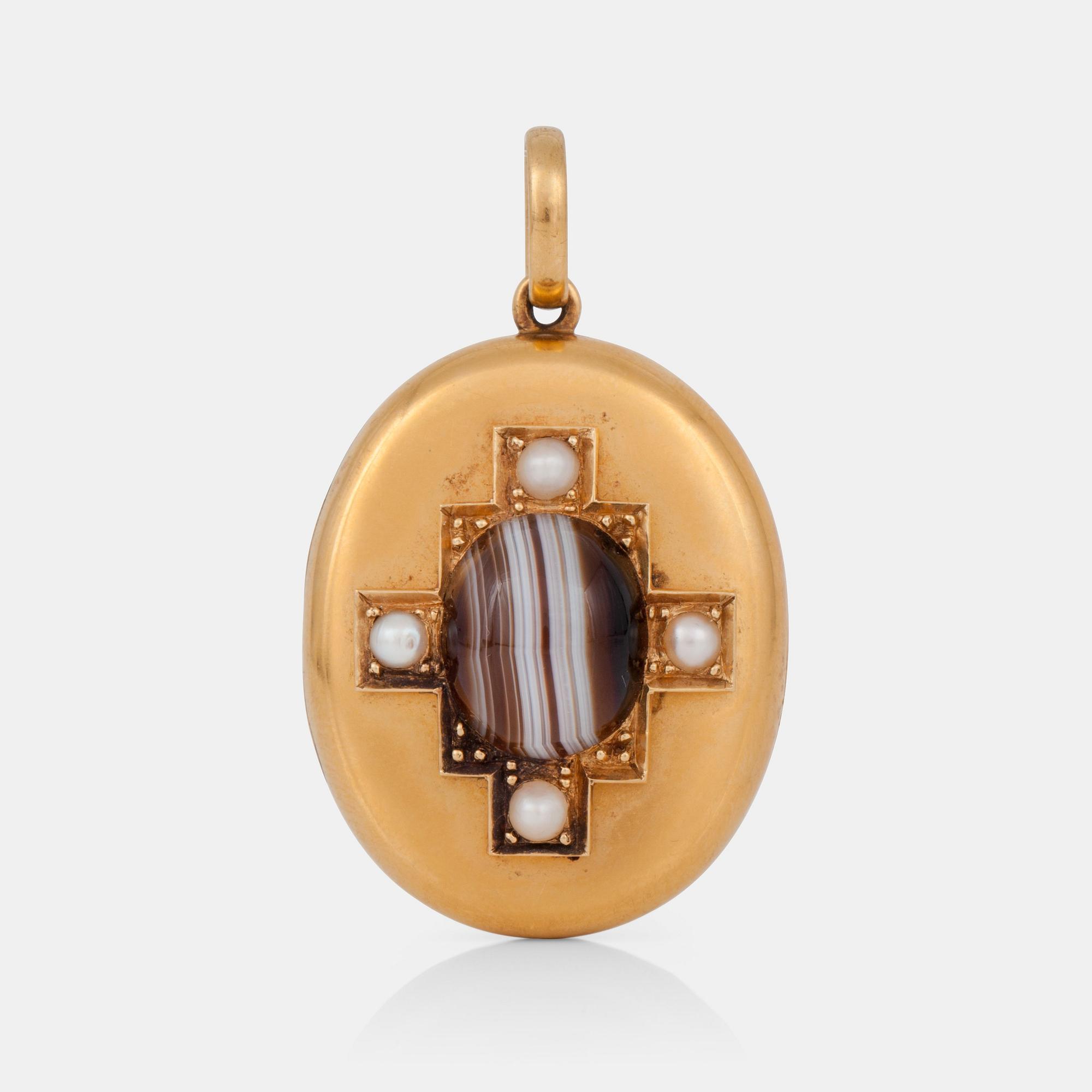 A Victorian pendant locket, decorated with a cross of pearls and a cabochon cut agate.