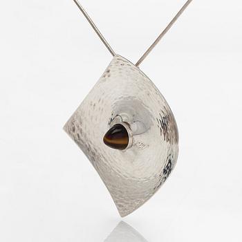Elis Kauppi, a silver brooch/pendant, and tiger's eye. Kupittaan Kulta, Turku 1962.