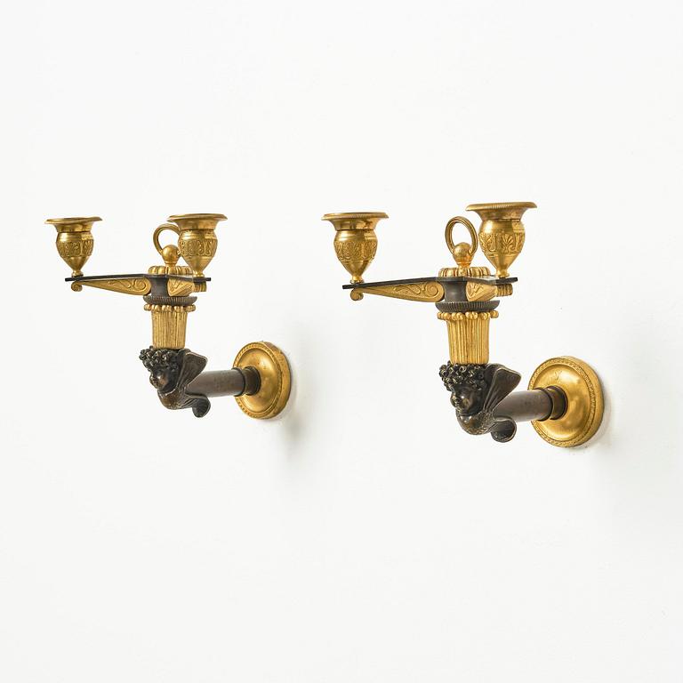 A pair of Empire patinated and ormolu two-branch appliques attr. to C. Galle (bronzier in Paris 1786-1815).