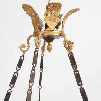 An Empire.style five-branch patinated and gilt bronze chandelier, later part of the 19th century.