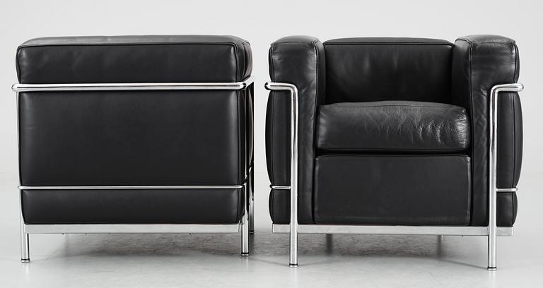 A pair of Le Corbusier 'LC 2' black leather and chromed steel easy chairs, by Cassina, Italy.
