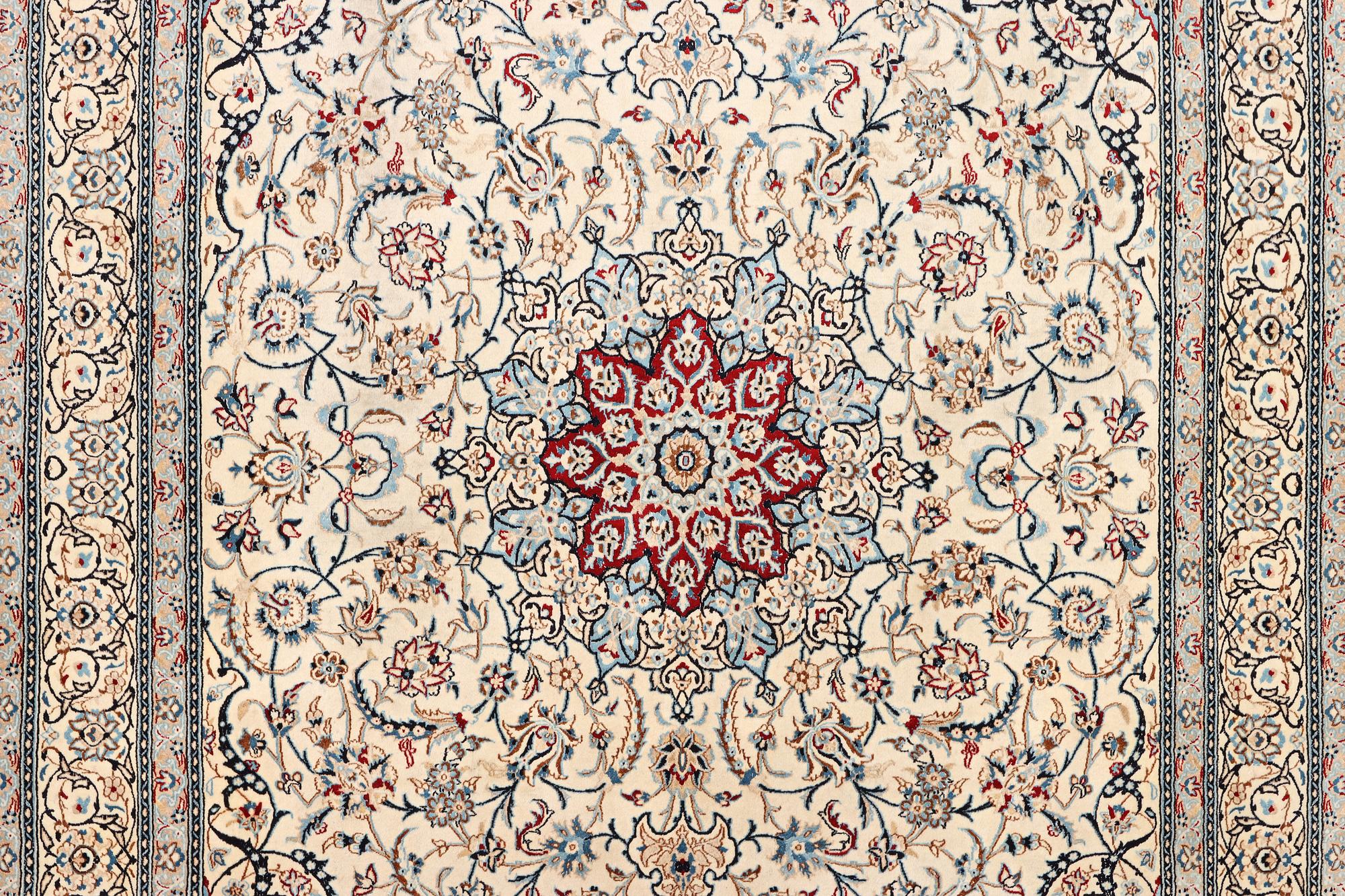 A Nain carpet, part silk, 9 laa, c. 390 x 295 cm.