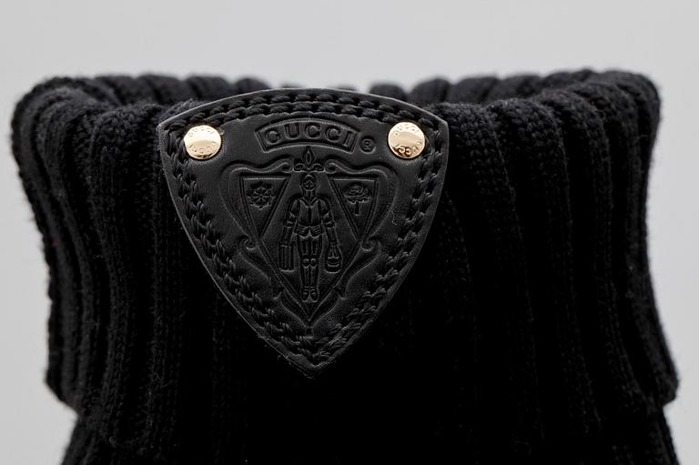 A pair of black boots from Gucci.