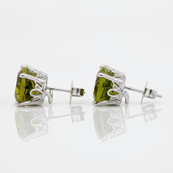 A pair of peridot and yellow cultured south sea pearl earrings.