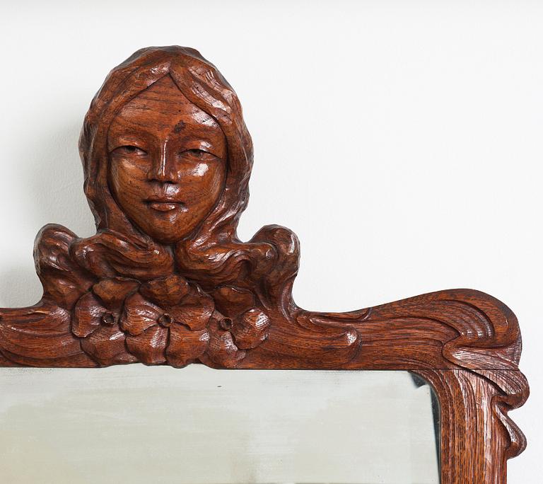 An Art Nouveau oak wall mirror with a console table.