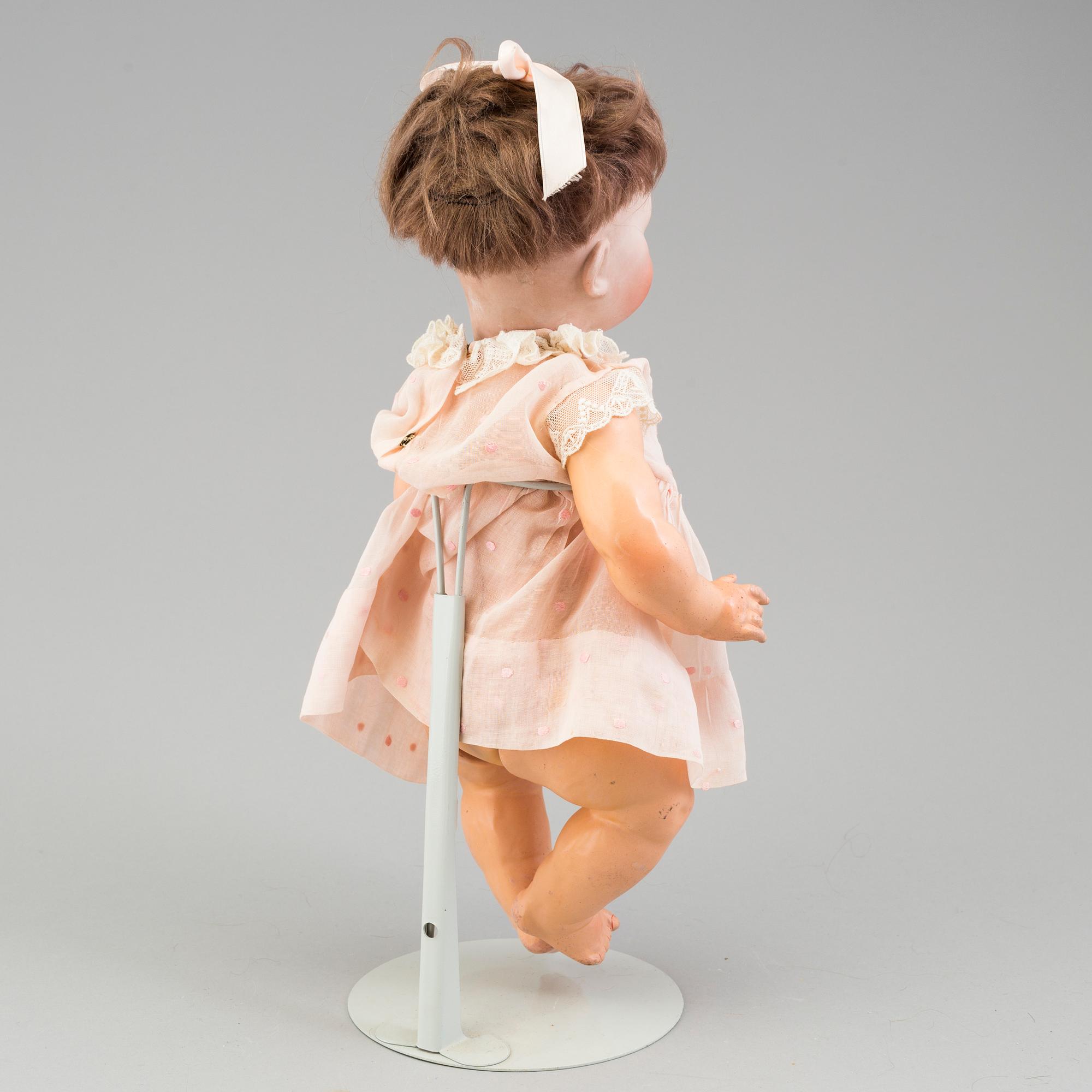 a porcelain doll from the early 20th century.