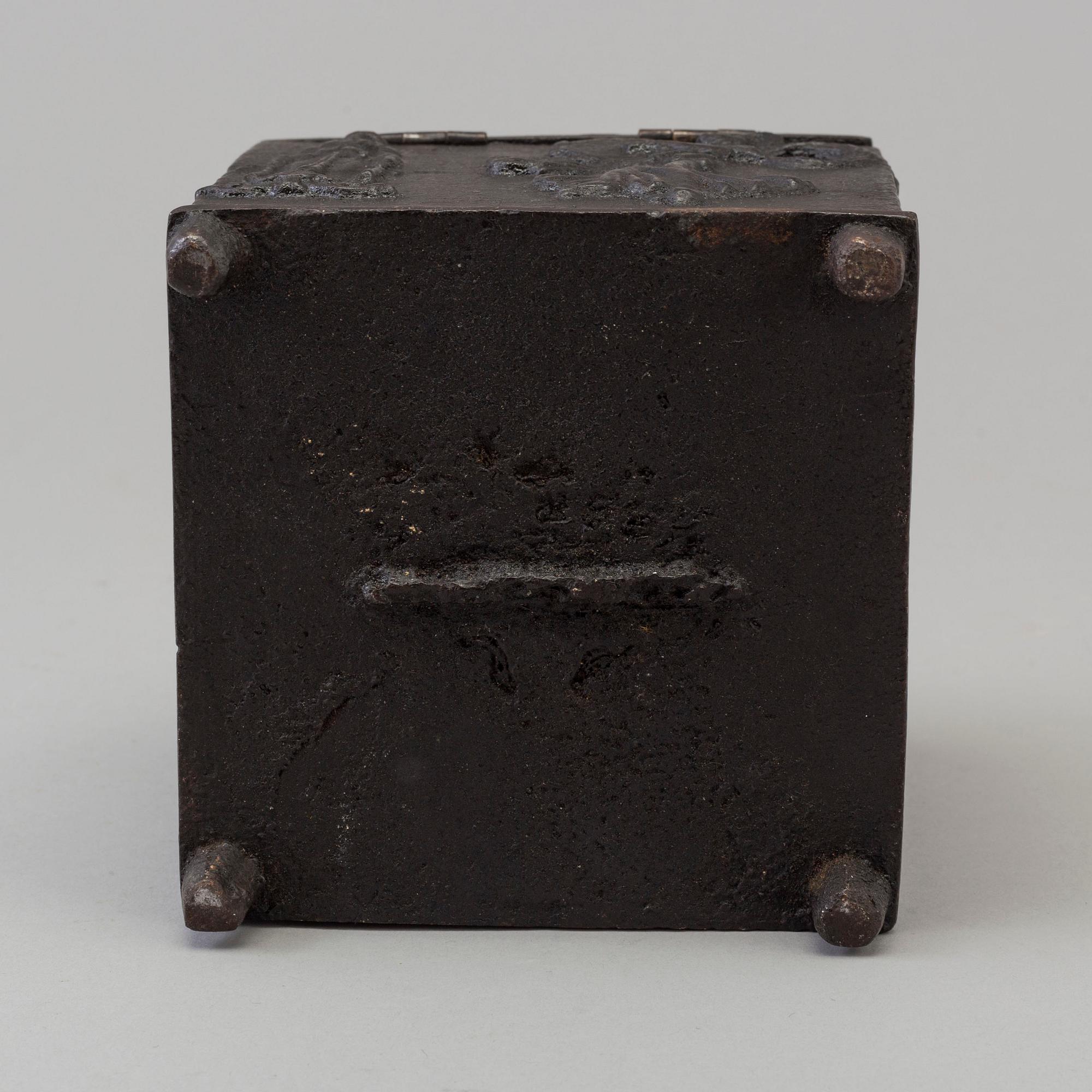 An empire cast iron tobacco box, dated 1838.