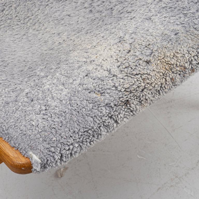 Yngve Ekström, a 'Lamino' armchair with ottoman and sidetable, Swedese, Sweden, 21st century.