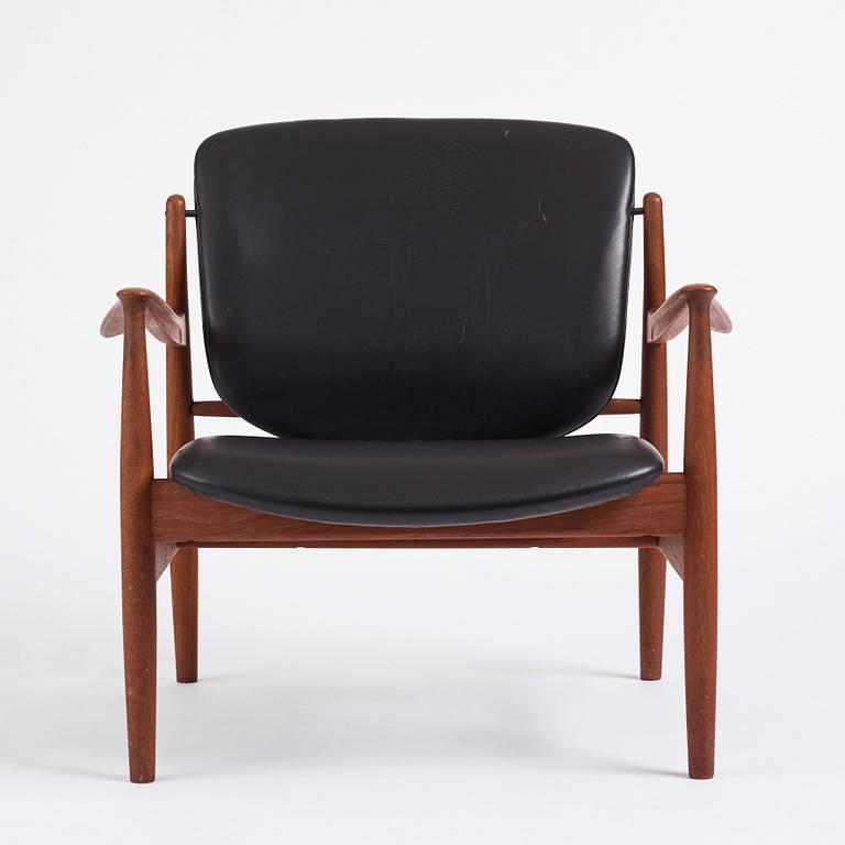 Finn Juhl, a teak and black leather 'model 136' easy chair, France & Daverkosen, Denmark 1950-60s.