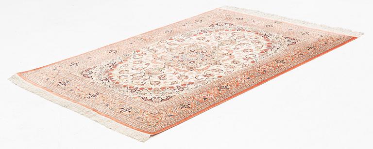 A signed silk Qum rug, ca 197 x 136 cm.