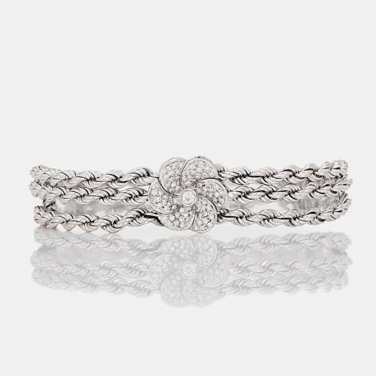 A brilliant-cut diamond flower bracelet.