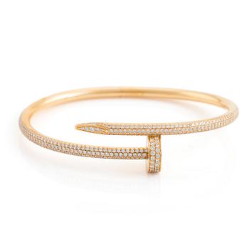 592. A Cartier "Juste un Clou" bracelet in 18K gold set with round brilliant-cut diamonds.