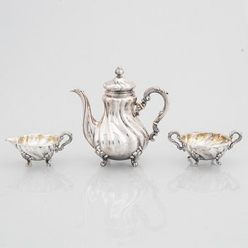 A Rococo Style Silver Coffee Pot, Creamer and Sugar Bowl, 20th Century, Swedish import mark.