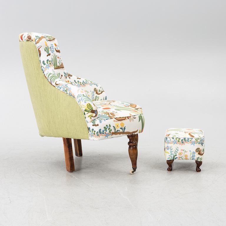 A corner lounge chair/sofa with a small ottoman, presumably early 20th century.