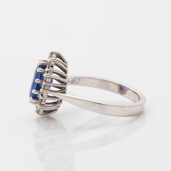 Oval faceted sapphire and brilliant-cut diamond ring.