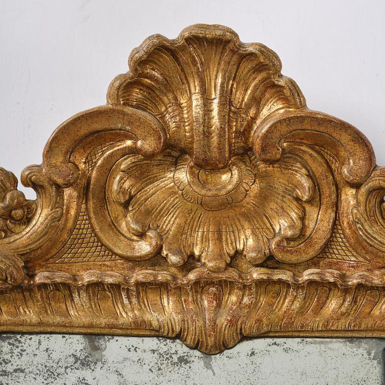 A two-branch giltwood rococo girandole mirror, Stockholm, later part 18th century.