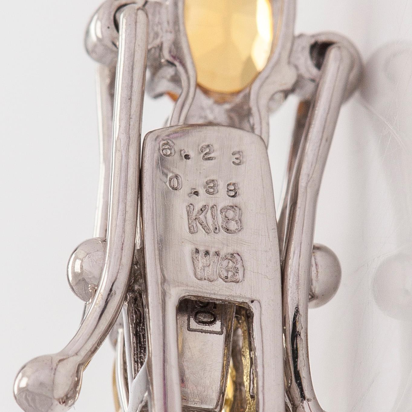 Rannekoru, 18K valkokultaa, monivärisillä safiireilla ja timanteilla.