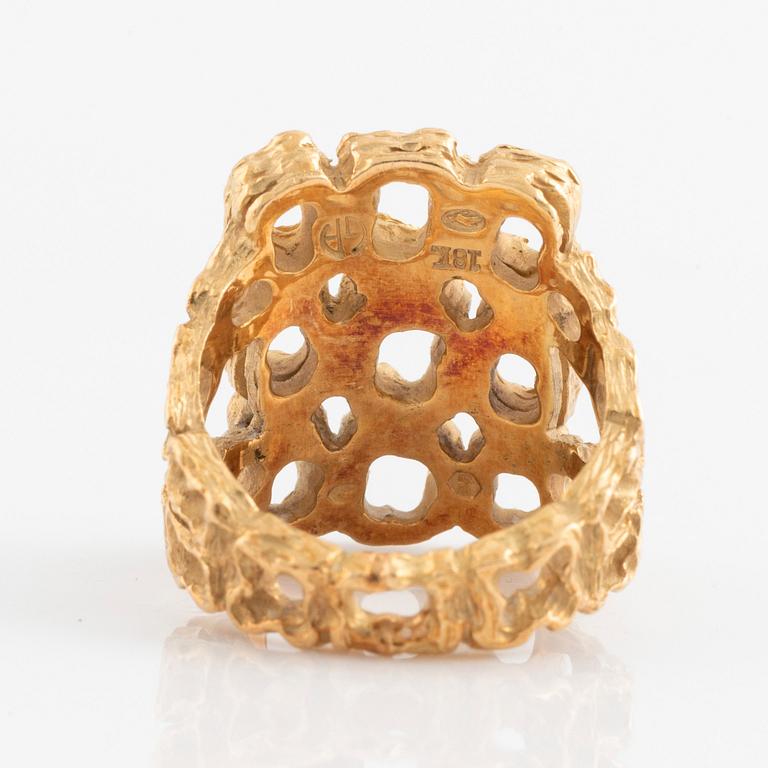 A Gilbert Albert ring in 18K gold.