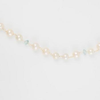 Ole Lynggaard clasp in 18K gold with a necklace of cultured freshwater pearls.