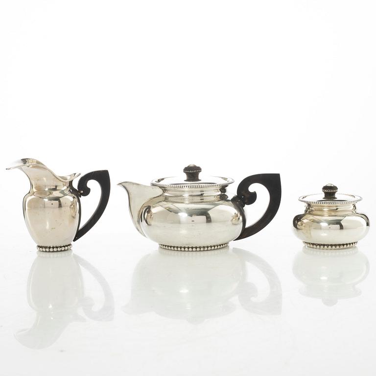An Italian silver teapot, cream jug and sugar bowl, 20th century.