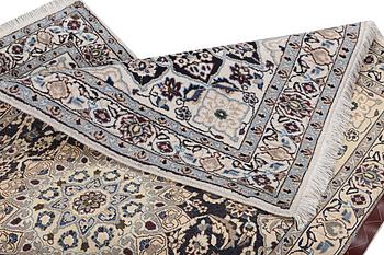 A Nain rug, part silk, 9 laa, c. 210 x 119 cm.