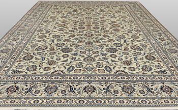 A Keshan carpet, signed, approx. 398 x 301 cm.