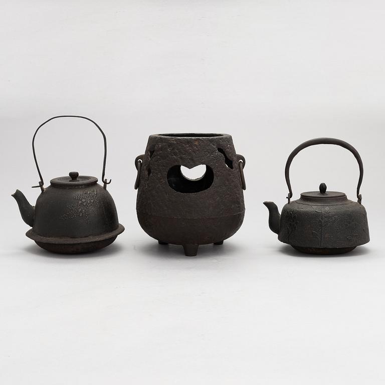 Two teapots and a hibachi brazier, Japan, early/ first half of the 20th century.