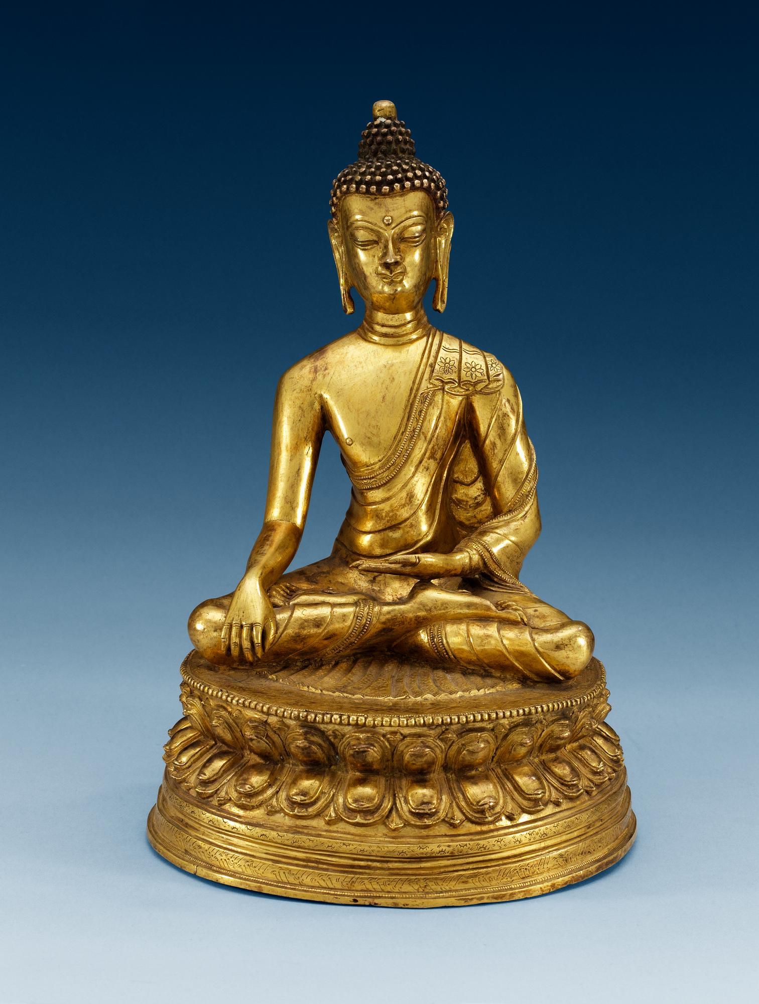 A gilt bonze sinotibethan figure of a seated Buddha, 19th Century.