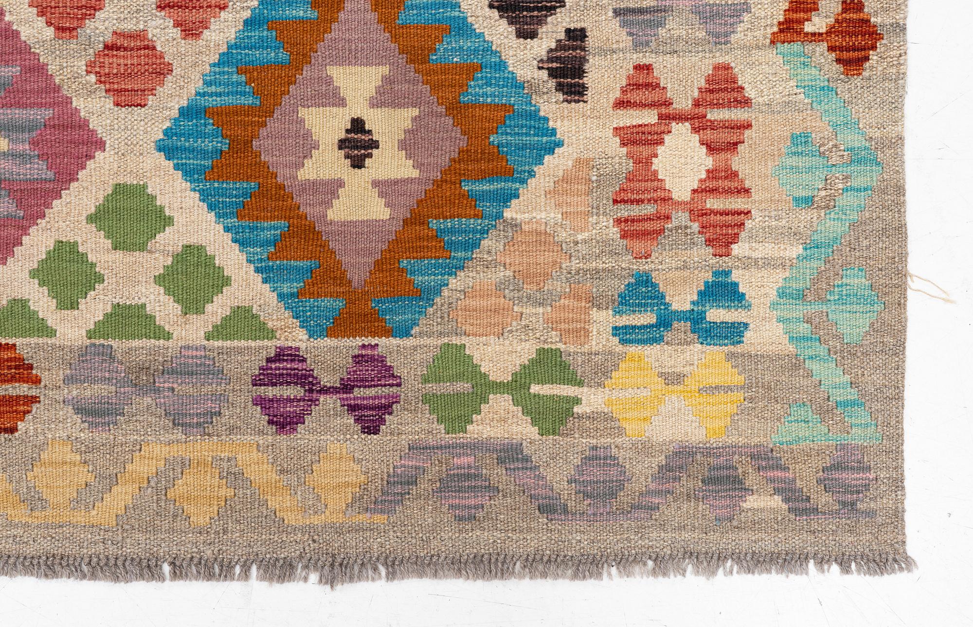 A Kelim rug, c. 252 x 180 cm.