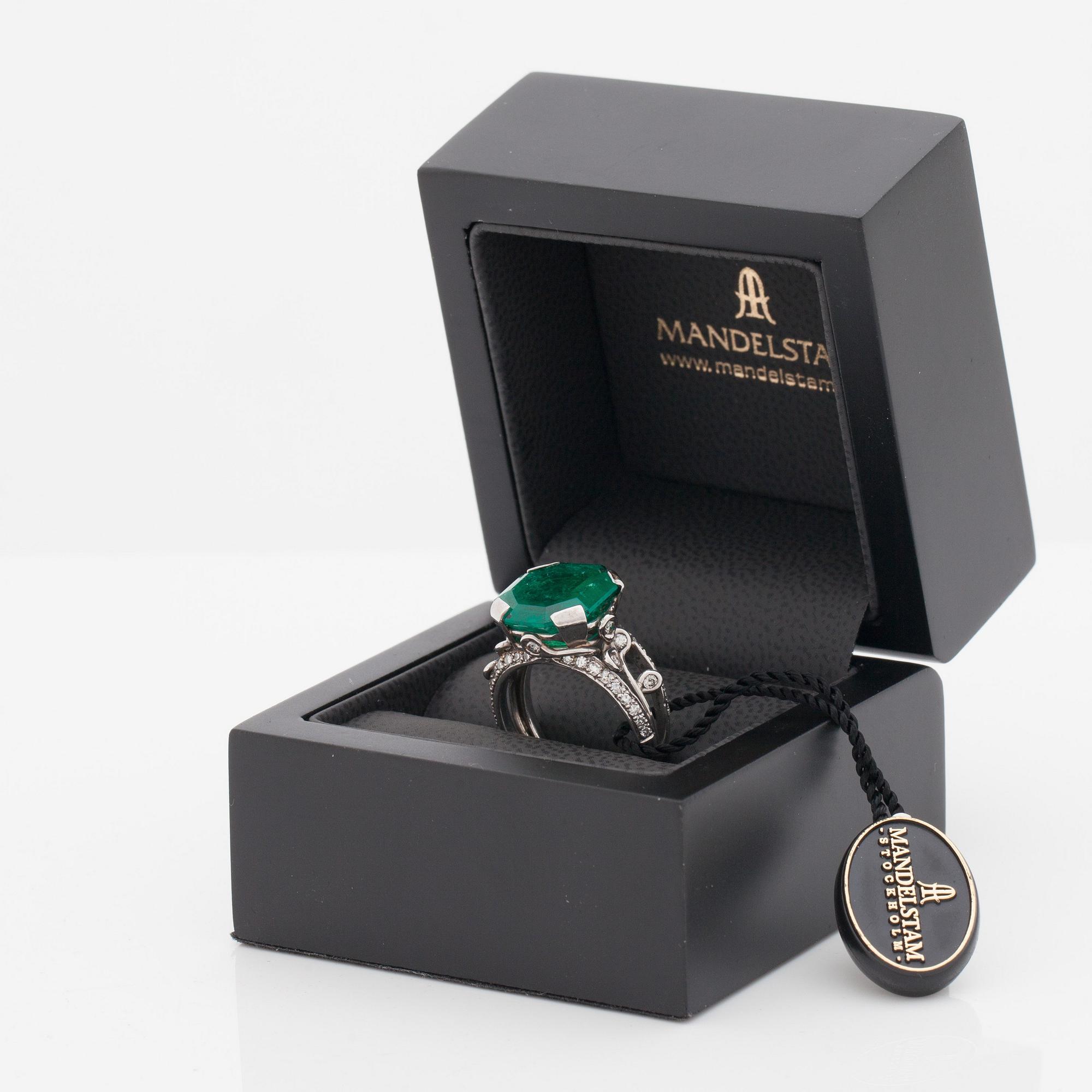 An octagonal cut 6.50 ct emerald and brilliant cut diamond ring. Mandelstam 'Ice Age'.