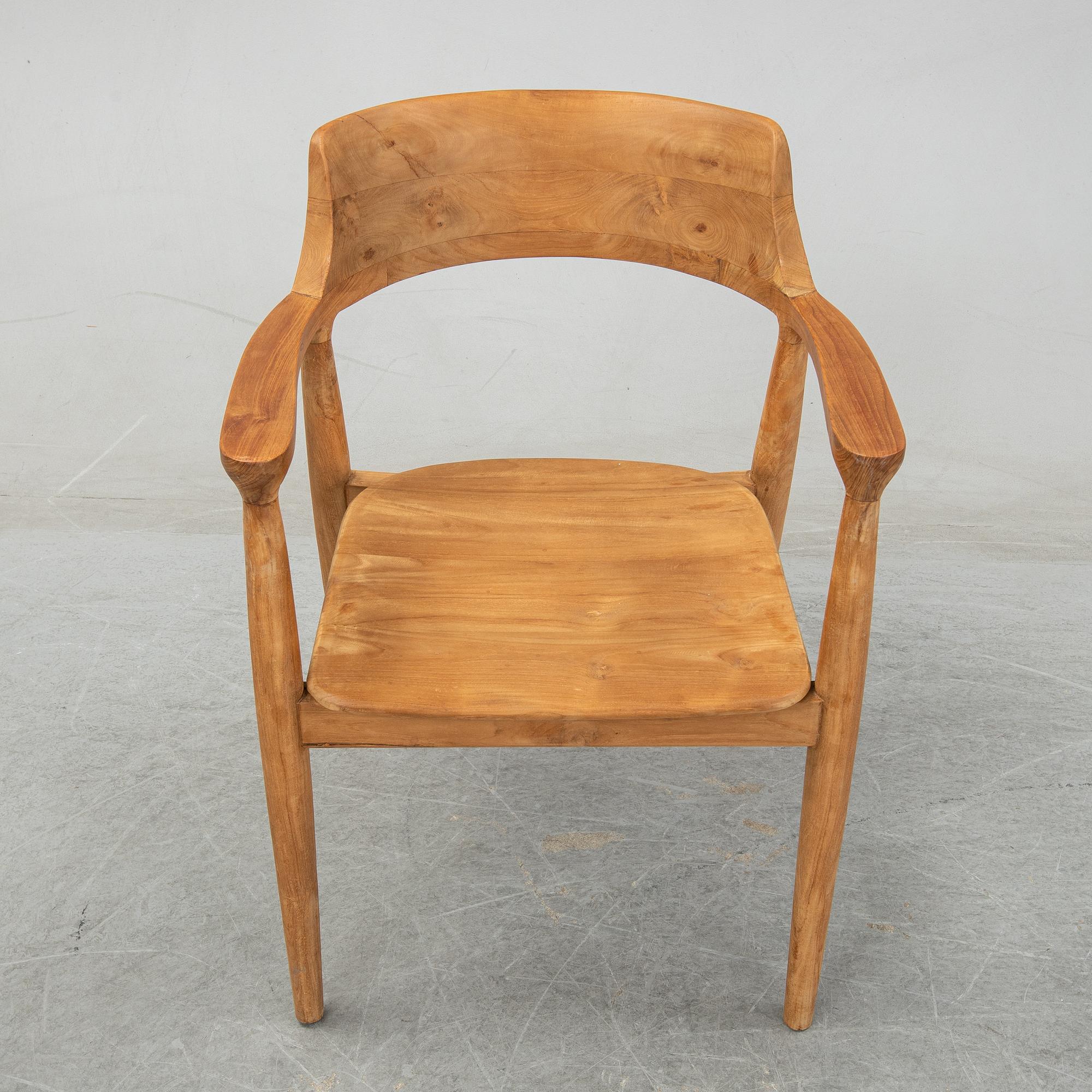 Four contemporary teak armchairs.