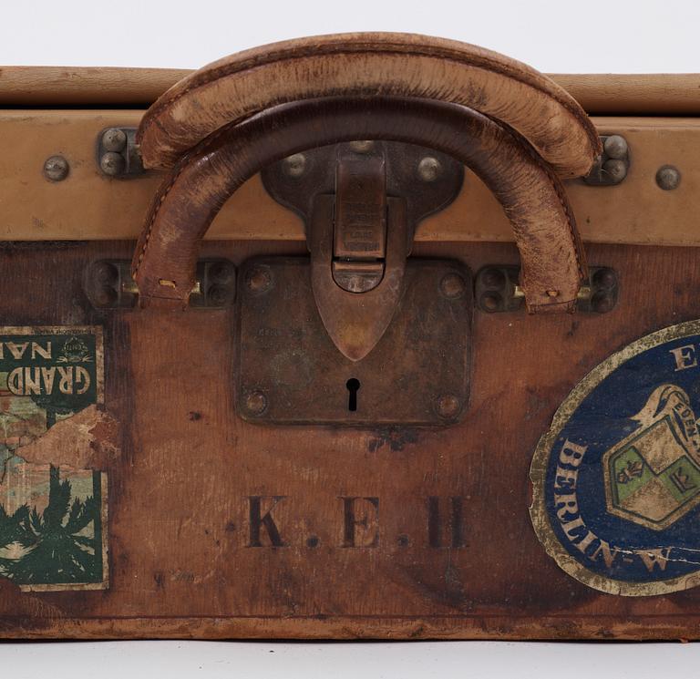 A late 19th cent leather suitcase by Louis Vuitton.