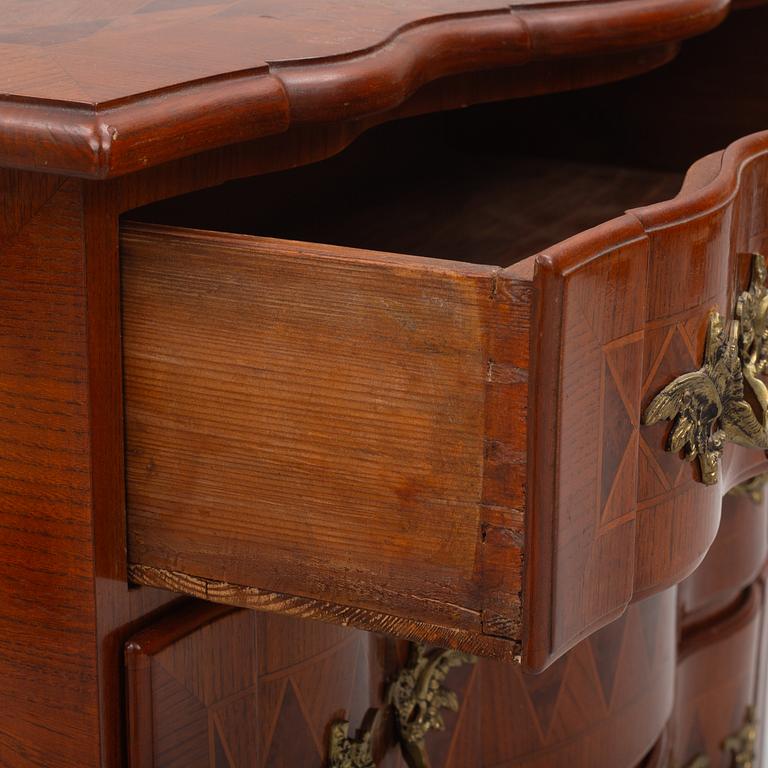 A Baroque style chest of drawers, circa 1900.