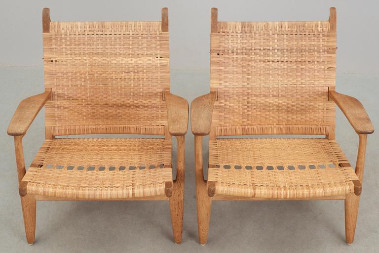 A pair of Hans J Wegner oak and rattan 'CH-27' armchairs, Carl Hansen & Son, Denmark, 1950's-60's.