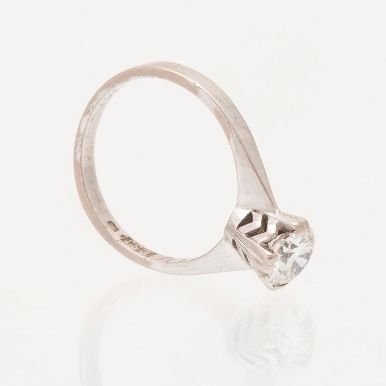 An 18K white gold solitaire ring set with a round brilliant cut diamond.