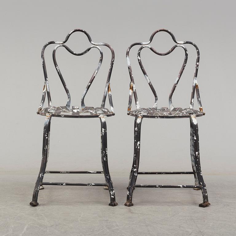 a pair of modern iron graden chairs,