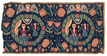 320. A carrige cushion, "Bebådelsen", tapestry weave, ca 95 x 47,5 cm, Skåne, 1800-1830.