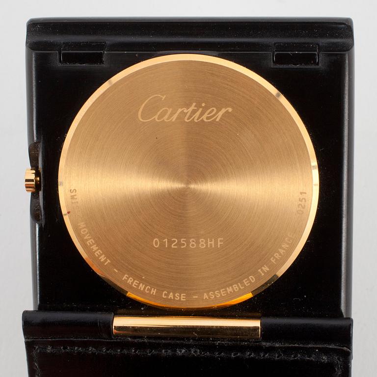 CARTIER, a travelwatch in a black leather case.
