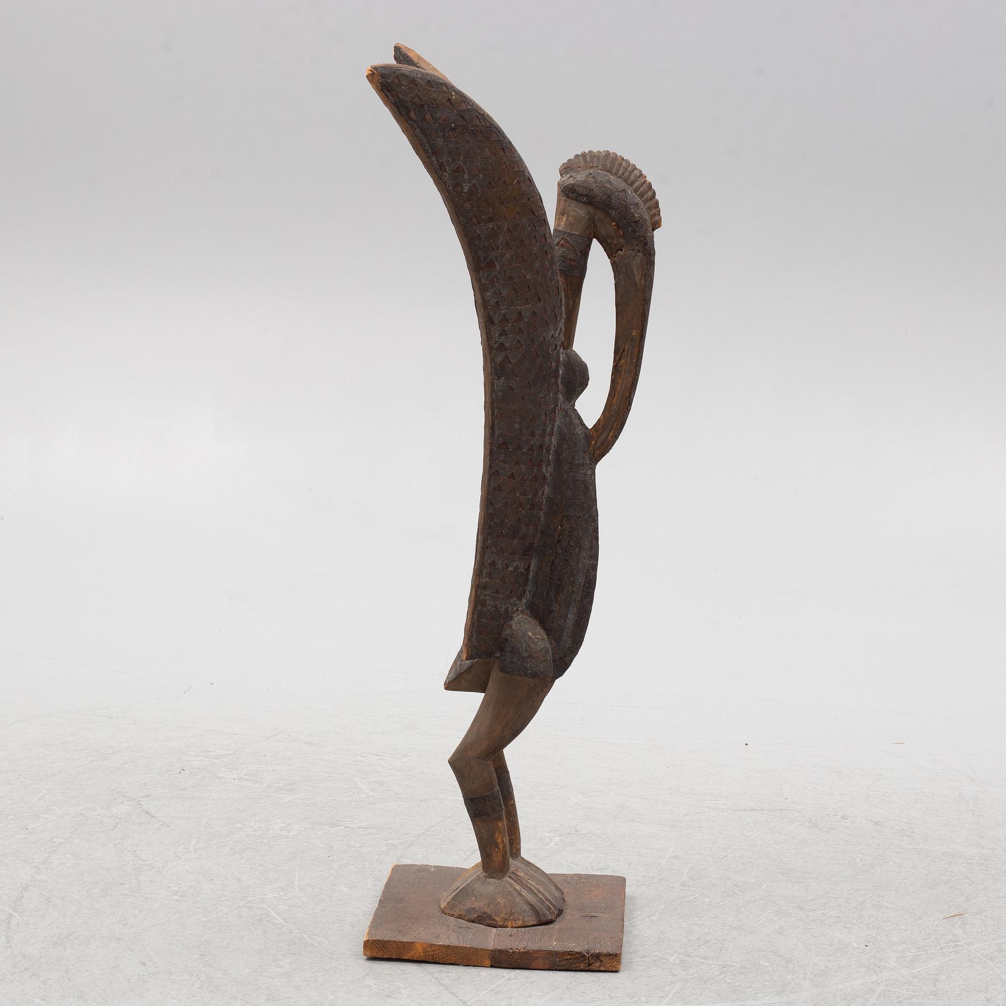 A sculpture, likely Ivory Coast, 20th century.