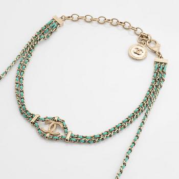 Chanel, a silver tone pearl and leather necklace.