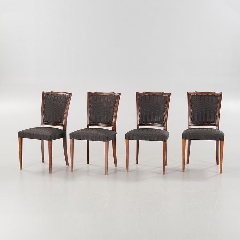 An english style dining table and eight chairs, second half of the 20th century.