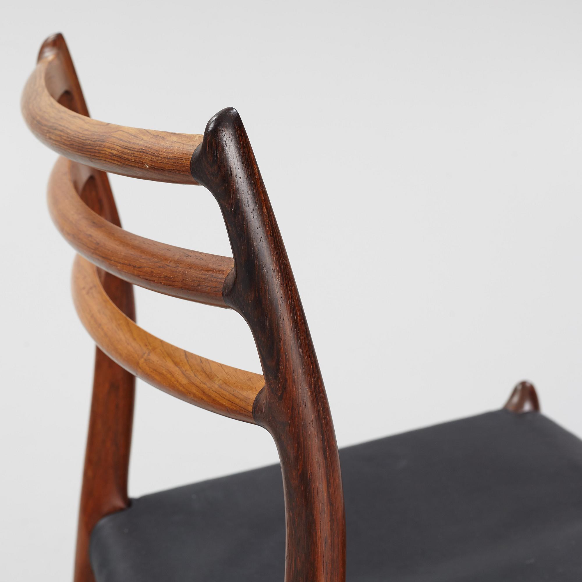 Niles Otto Møller, a rosewood veneered table with four chairs, JL Møller, Denmark, 1950's/60's.