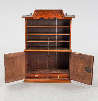 A late Baroque burr alder-veneered cabinet, first part of the 18th Century.