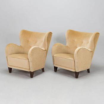 A pair of mid-20th century armchairs.