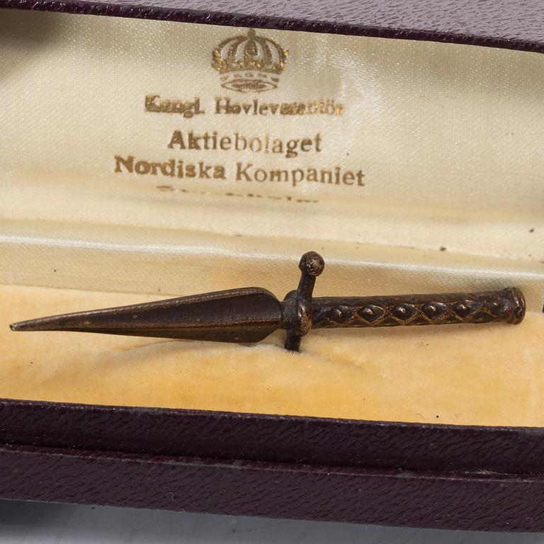 An aluminium bucket, a wooden case, four rings and two miniature knives, Finland and Russia, early 1900s.