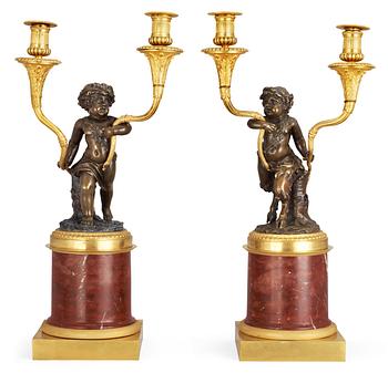 A pair of Louis XVI-style 19th century gilt and patinated bronze and red marble two-light candelabra.